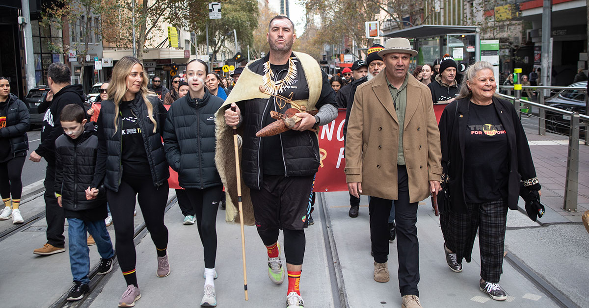 Kerrupmara Gunditjmara man Travis Lovett completes the final steps of the Walk for Truth, through Melbourne CBD